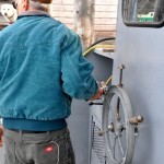 Jerry Vanlandschoot maneuvers the Joy out of the Leland River. Because of narrow spaces, the Joy must move backwards.